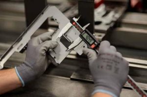 metal stamping parts manufacturer first article inspection with caliper